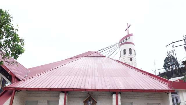 Modern Church with Unique Red Roof and Cross Tower