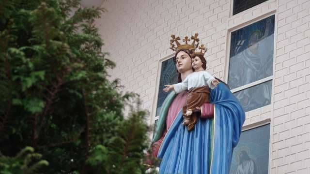Majestic Virgin Mary and Child Statue Outside Church