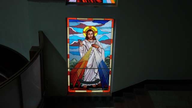 Stained Glass Jesus Illuminates Church Stairwell