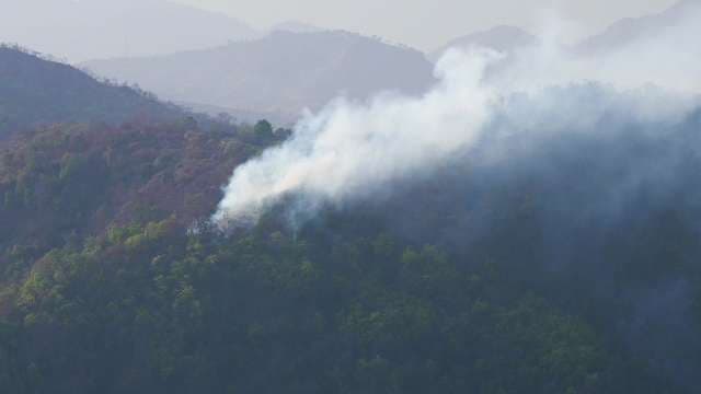 Forest Fire Spreads Smoke Across Mountainous Landscape