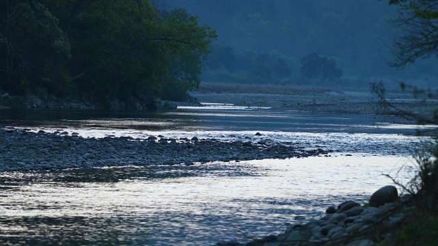 Serene Riverside Landscape at Dusk With Flowing Stream