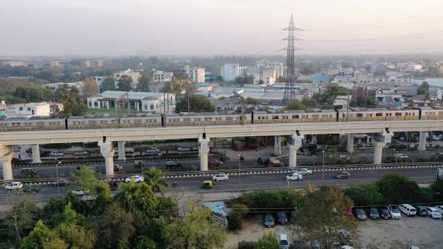 Delhi Metro Train on Elevated Track Above City Traffic