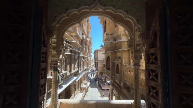 Exploring Patwon Ki Haveli: Ornate Facade and Bustling Lane in Jaisalmer