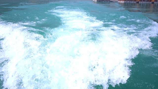 Boat Wake Patterns on Clear Blue Water