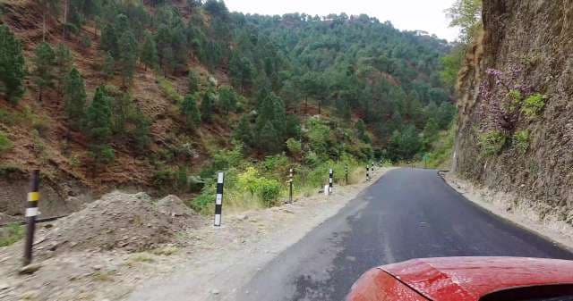 Scenic Drive Through Mountain Road With Lush Green Forest
