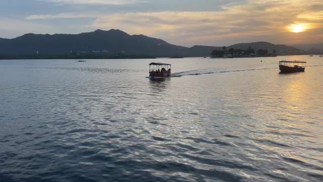 Sunset Boat Ride Across Lake With Scenic Mountain Views