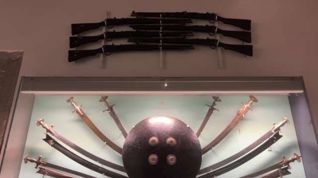 Historic Swords, Shields, and Rifles Displayed in Museum Gallery Udaipur