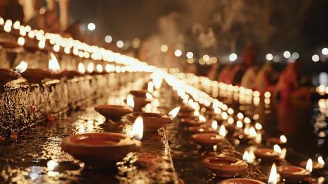 Diwali Diyas Illuminate Night Along Indian Riverbank