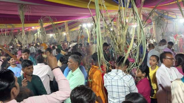 Vibrant Chhath Puja Celebration With Devotees and Sugarcane Canopies