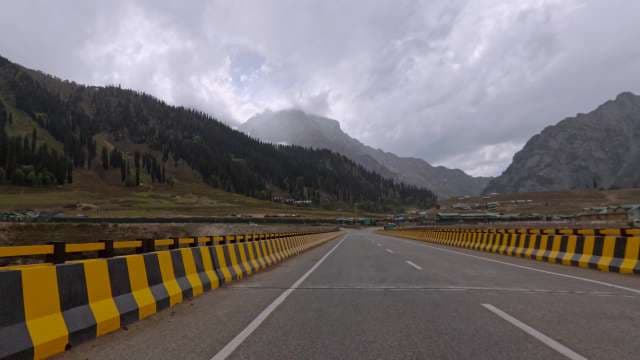 Breathtaking Mountain Highway Amid Misty Peaks