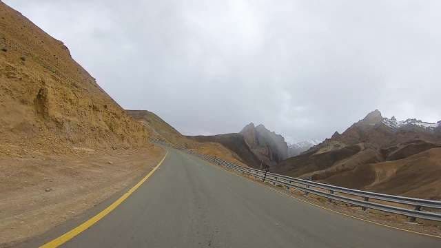 Breathtaking Mountain Road Drive Through Snow-Capped Peaks