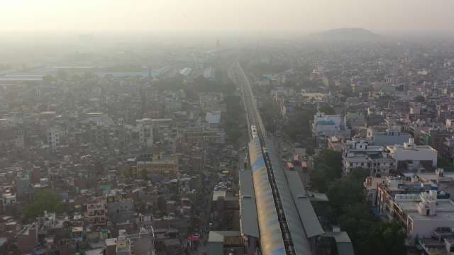 Aerial View of Elevated Train Over Delhi Cityscape