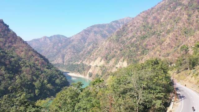 Himalayan Valley: Turquoise River Through Forested Mountains