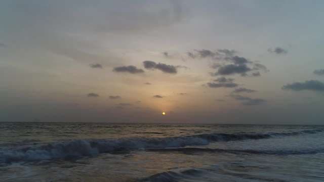 Serene Ocean Sunset with Golden Sky and Waves