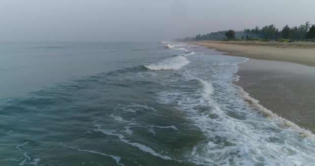 Aerial View of Serene Coastal Beach with Crashing Waves