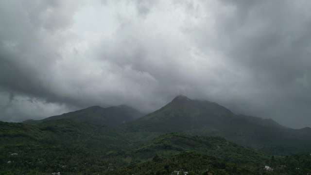 Misty Mountain Peak Shrouded in Clouds and Fog