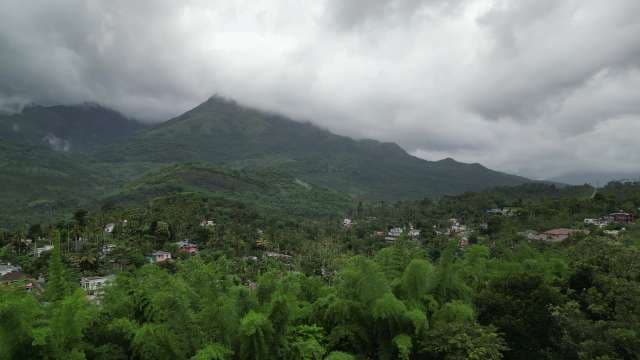 Misty Mountain Village Surrounded by Lush Green Forest