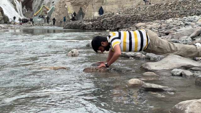 Man Drinking Water From The Spiti River 