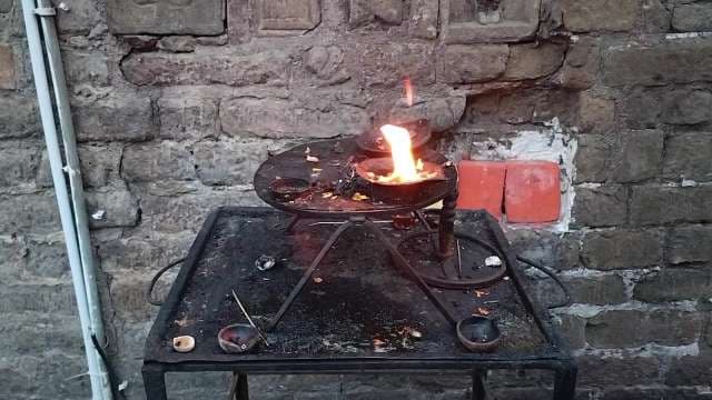 Outdoor Fire Pit Bowl Burning Bright Against Stone Wall