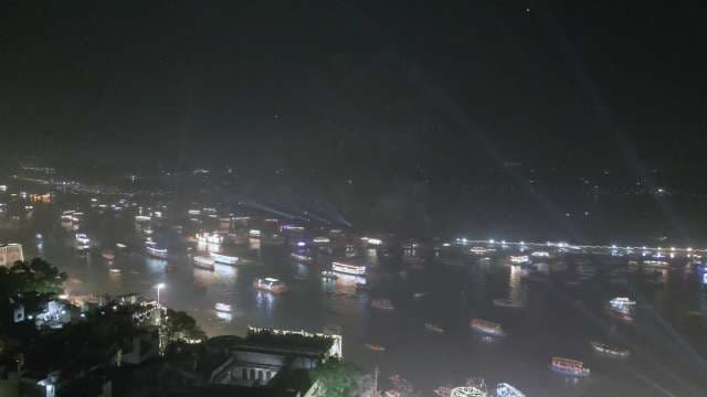 Nighttime River Port Activity: Illuminated Waterfront Cargo Vessels