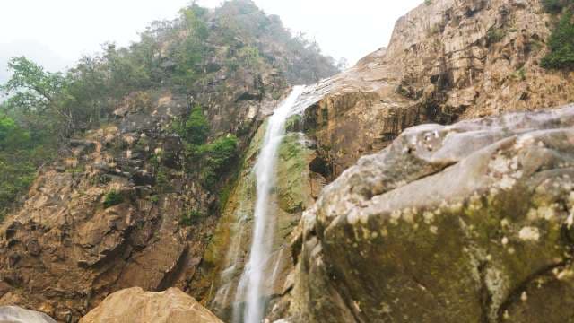 Majestic Rainbow Falls Cascading Through Rocky Canyon