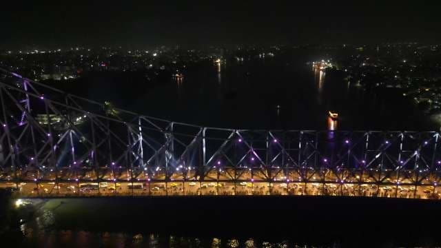 Iconic Howrah Bridge Illuminated at Night Over the Hooghly River