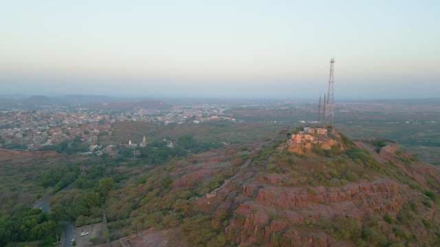 Aerial View of Jodhpur Cityscape and Rocky Hills at Sunset