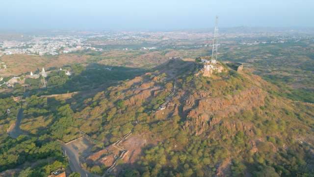 Panoramic Aerial View of a Rugged Hillside Overlooking a Desert City