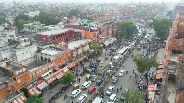 Bustling Street Traffic and Historic Architecture Near Hawa Mahal in Jaipur