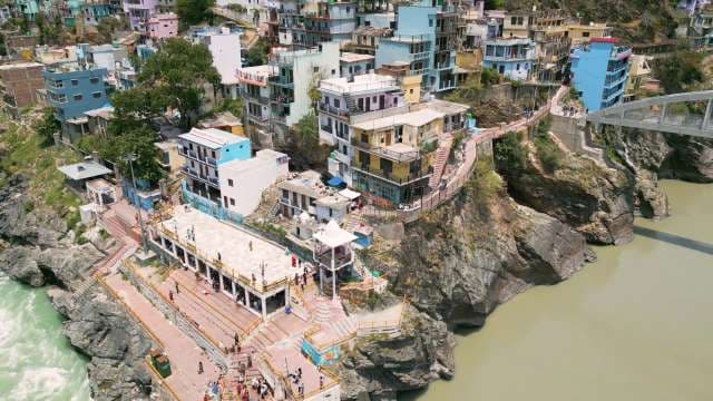 Aerial View of Colorful Buildings Along the Ganges River in Rishikesh