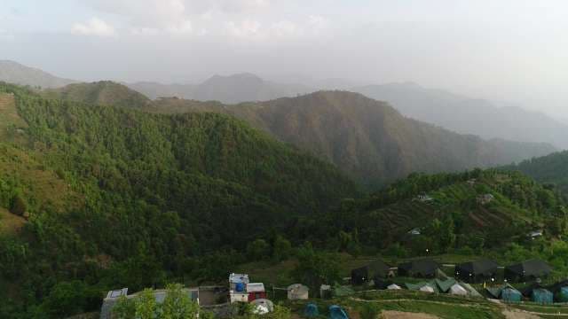 Scenic View of Lush Green Mountain Valleys and Hazy Peaks