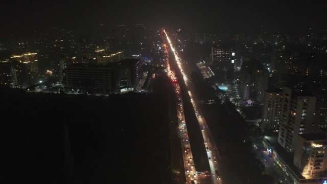 Aerial View of Busy City Highway Traffic and Urban Lights at Night