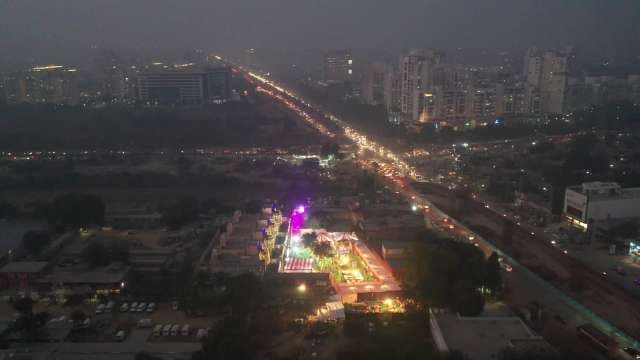 Night Aerial View of Busy Highway Traffic and Festive Event Venue
