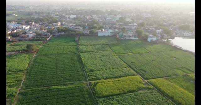 Scenic Aerial View of a Rural Village and Green Farmland