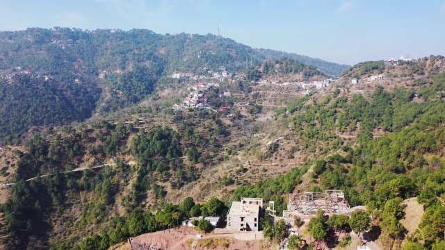 Scenic Aerial View of Houses on Lush Himalayan Mountain Slopes