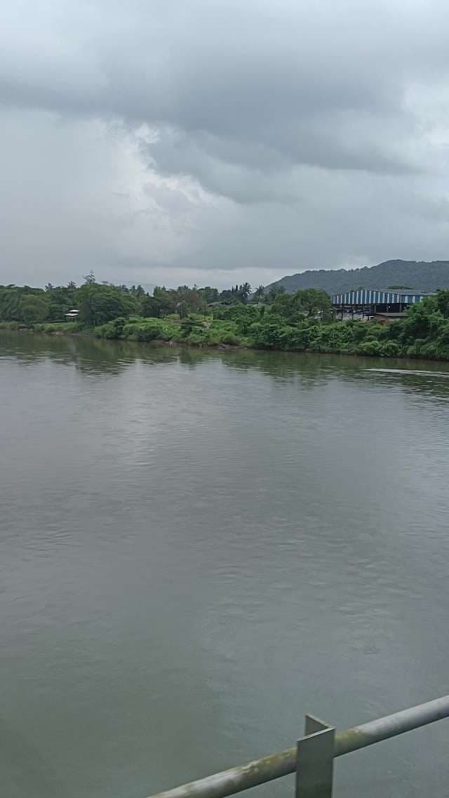 Peaceful View of a Wide Tropical River Under Cloudy Monsoon Skies
