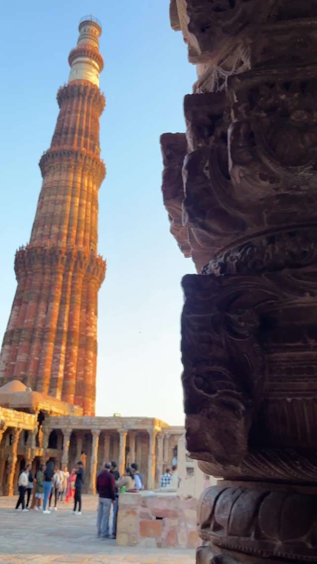 Historic Qutub Minar Minaret and Ancient Stone Carvings in Delhi