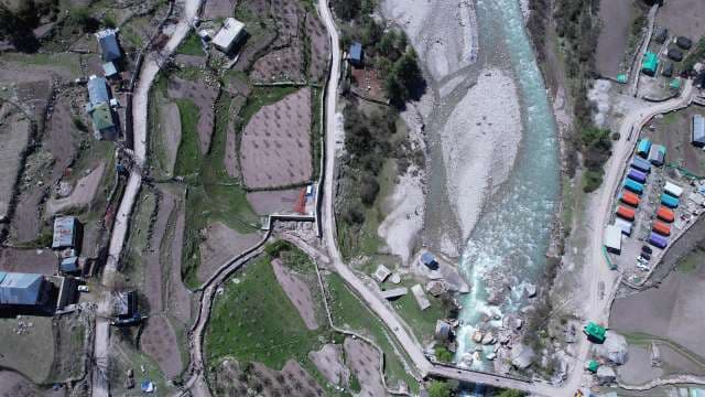 Top-Down Aerial View of Turquoise River and Rural Mountain Valley