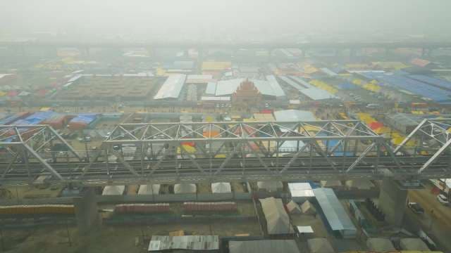 Aerial View of Kumbh Mela Tents and Railway Bridge in Fog