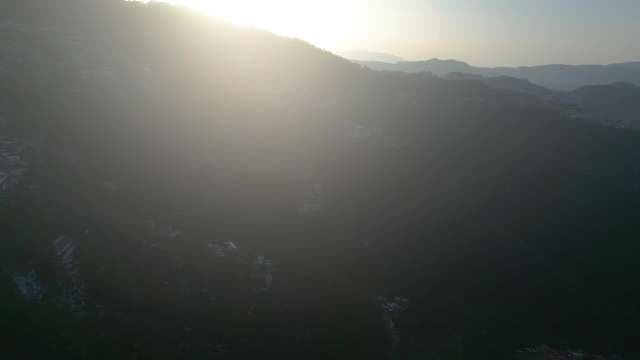 Cinematic Sunburst and Lens Flare Over Misty Mountain Range
