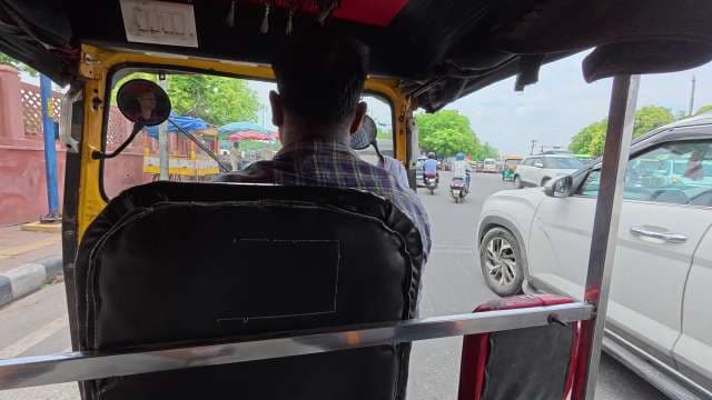 Auto Rickshaw Ride Through Busy City Streets in India