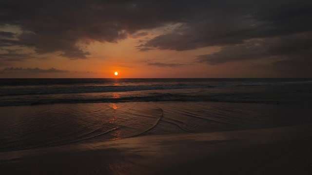 Stunning Golden Sunset Over Calm Tropical Beach Waves