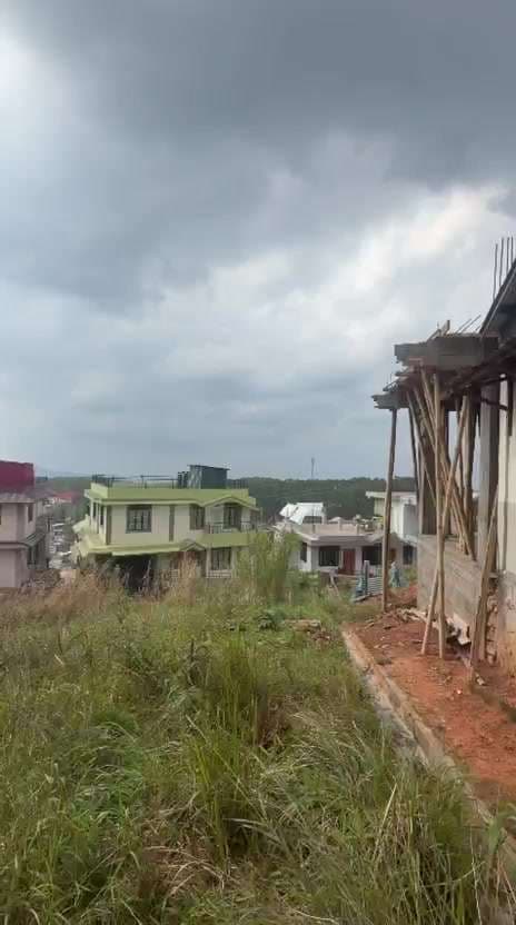 Hillside Residential Area with New Building Construction Under Cloudy Sky