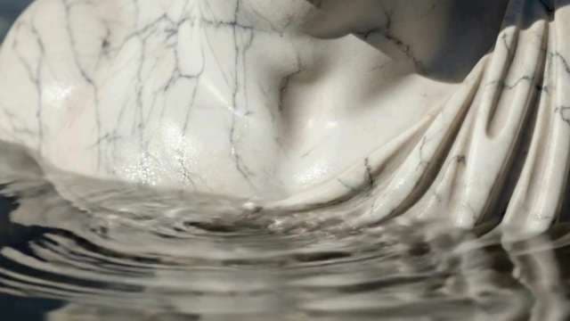 Close-Up of White Marble Statue Submerged in Rippling Water