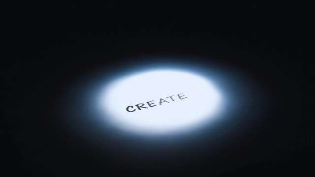 Motivational Word Create Under Spotlight on Dark Background