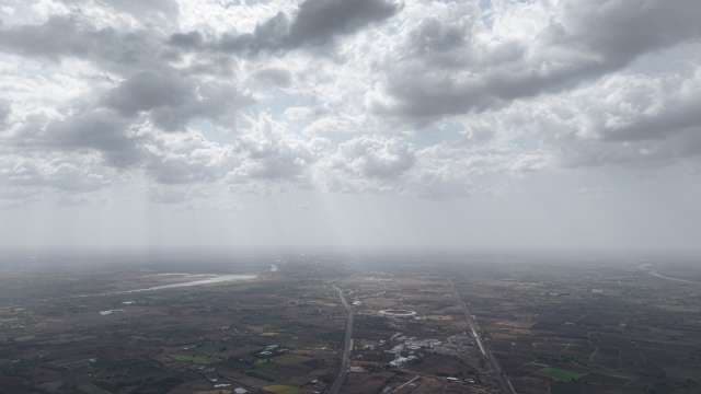 Aerial View of Dramatic Clouds and Sunbeams over Rural Landscape
