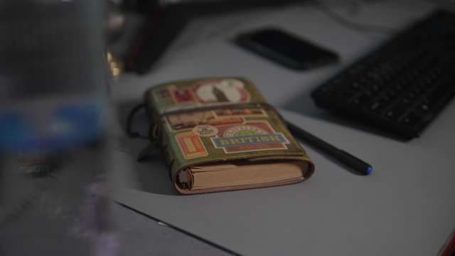 Vintage British Travel Journal on a Modern Workspace Desk