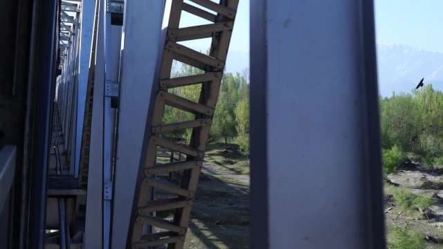Train Journey Crossing Steel Bridge Over Scenic Mountain Valley