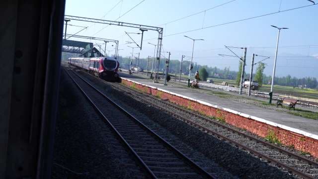 Red Passenger Train Arriving at Rural Station Platform