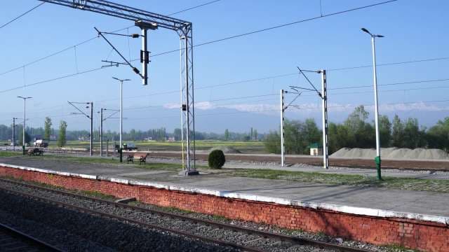 Scenic Empty Railway Platform with Distant Snow Mountains